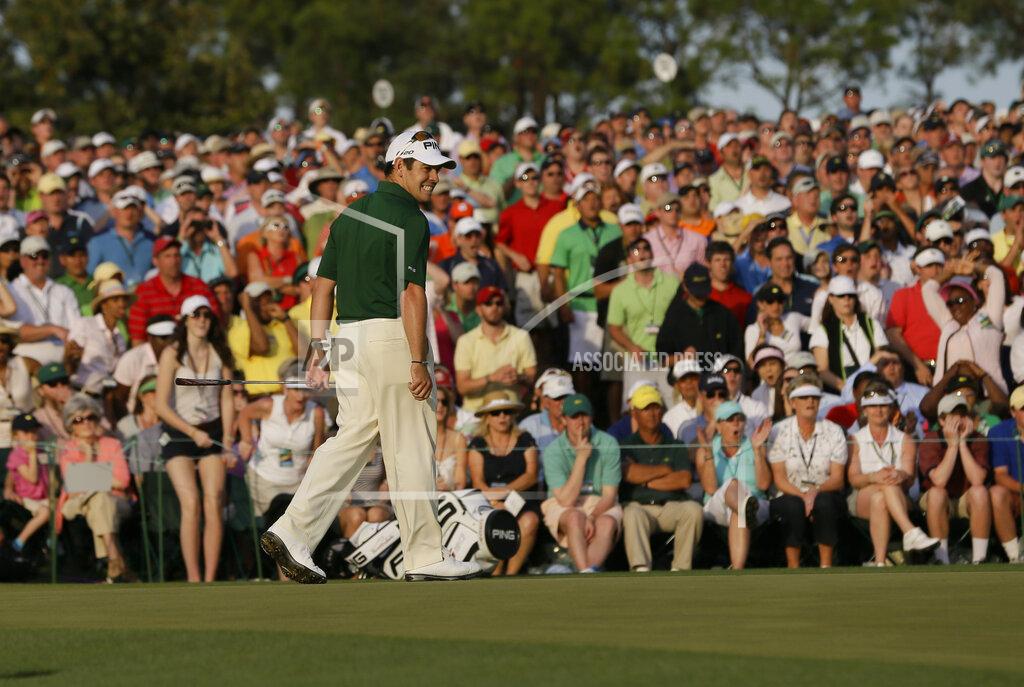 David J. Phillip FILE - Louis Oosthuizen, of South Africa, watches his putt on the 18th green during the fourth round of the Masters golf tournament in Augusta, Ga., in this Sunday, April 8, 2012, file photo. The 18th green will be missing patrons when the Masters champion wins a green jacket this year.(AP Photo/David J. Phillip, File)