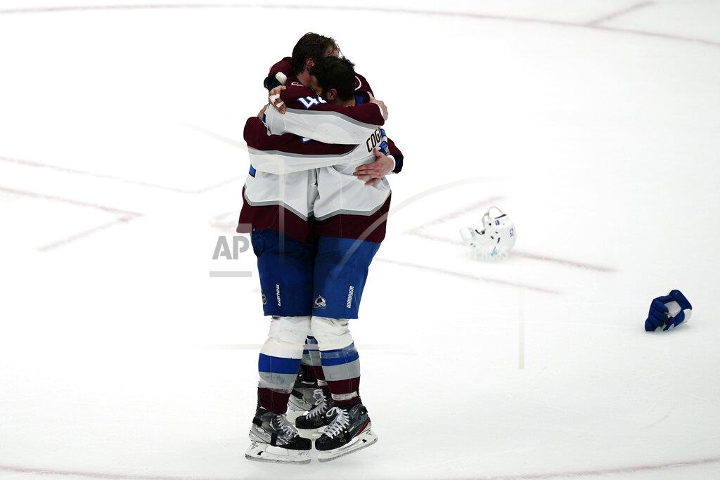 John Bazemore Colorado Avalanche defenseman Josh Manson (42), left, hugs center Andrew Cogliano (11) after the Avalanche defeated the Tampa Bay Lightning, 2-1 to win the NHL hockey Stanley Cup Finals on Sunday, June 26, 2022, in Tampa, Fla. (AP Photo/John Bazemore)