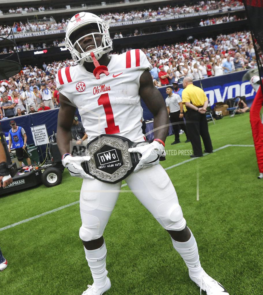 Joshua Mccoy In this Sept. 1, 2018, photo provided by the Mississippi Athletics Department, Mississippi wide receiver A. J. Brown displays the team's "Nasty Wide Outs" belt during an NCAA college football game against Texas Tech in Houston. College football sidelines across the country are featuring everything from wrestling-style robes to boxing gloves as teams try to mimic the success Miami had last season with its turnover chain. (Joshua McCoy, Mississippi Athletics Department via AP)