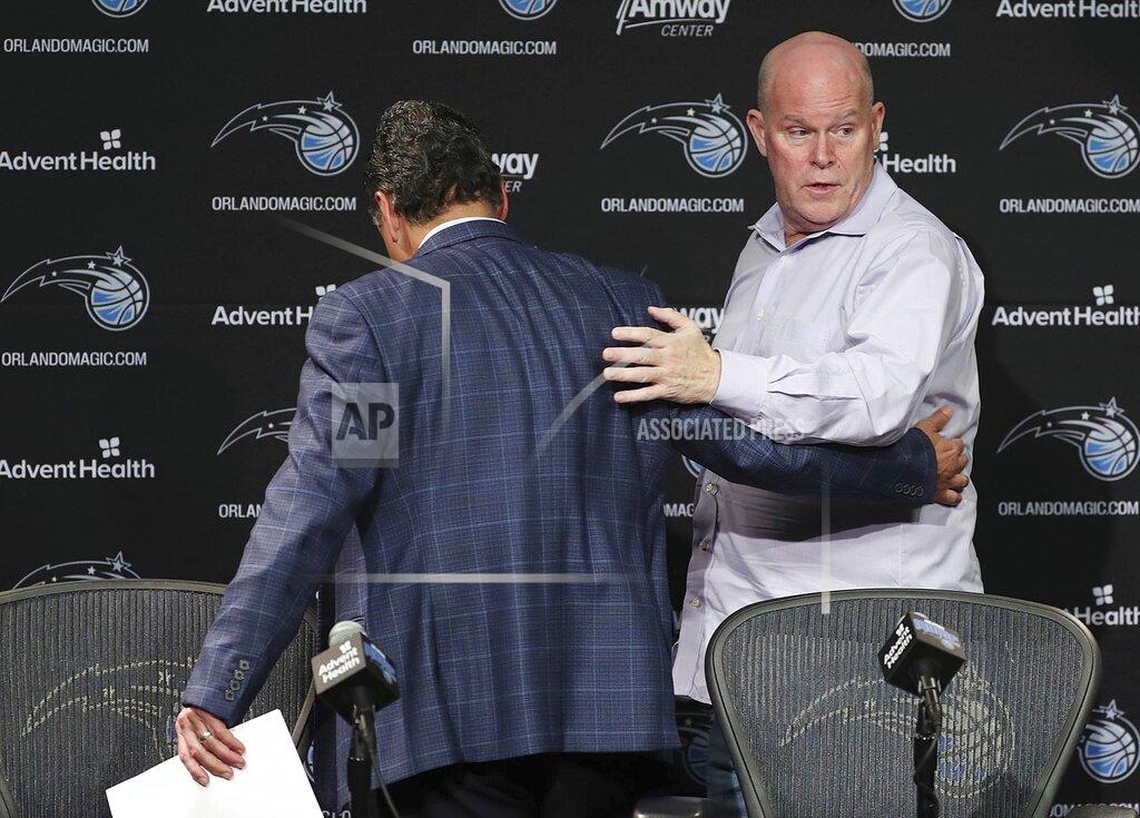 Stephen M. Dowell Orlando Magic CEO Alex Martins, left, leads Orlando Magic head coach Steve Clifford off the stage after a press conference at the Amway Center on Thursday, March 12, 2020. The NBA has suspended the season due to the coronavirus. (Stephen M. Dowell/Orlando Sentinel via AP)