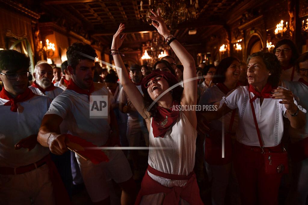 Alvaro Barrientos A woman dances "La Alpargata" at the end of the first day of the running of the bulls at the San Fermin festival in Pamplona, northern Spain, early Thursday, July 7, 2022. Revelers from all over the world flock to Pamplona every year to enjoy nine days of non-stop partying at the famous Pamplona running of the bulls, suspended the last two years due to the coronavirus pandemic.(AP Photo/Alvaro Barrientos)