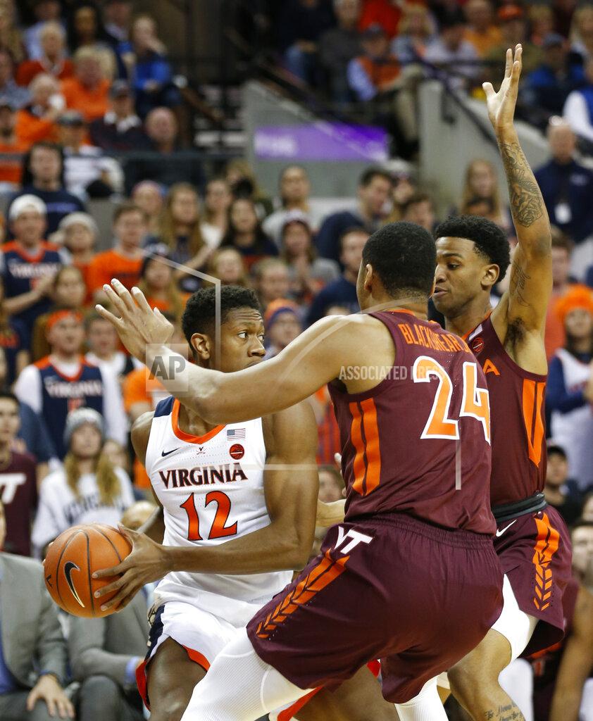 Steve Helber Virginia Tech forward Kerry Blackshear Jr. (24) and Virginia Tech guard Nickeil Alexander-Walker, right, press Virginia guard De'Andre Hunter (12) during the first half of an NCAA college basketball game in Charlottesville, Va., Tuesday, Jan. 15, 2019. (AP Photo/Steve Helber)