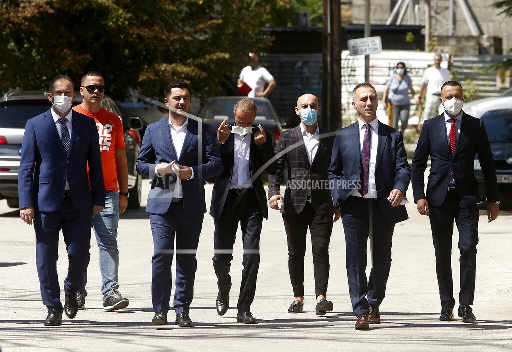 Boris Grdanoski Lawmakers and candidates for ministers of the ethnic Albanian DUI party walk towards the parliament building in Skopje, North Macedonia, Sunday, Aug. 30, 2020. North Macedonia's parliament continues Sunday the debate on a vote of confidence for a new left-wing coalition government after the Social Democrats and their ethnic Albanian partners secured a majority of seats in July's general election. (AP Photo/Boris Grdanoski)