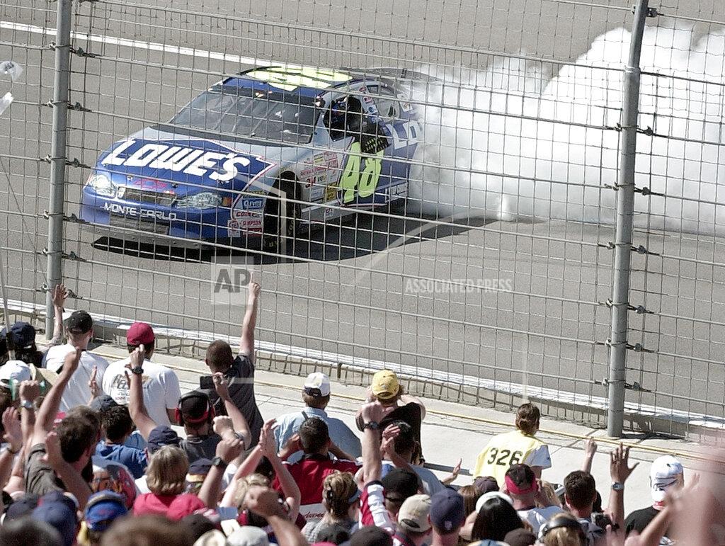 Mark J. Terrill FILE - In this April 28, 2002, file photo, Jimmie Johnson does a burnout in front of fans afer winning NASCAR auto race at California Speedway in Fontana, Calif. When Johnson won his first NASCAR Cup Series race at Fontana 18 years ago, this famously worn-out asphalt track had a whole lot less wear and tear. So did Johnson, who is visiting his home track this weekend for the last time as a full-time driver. (AP Photo/Mark J. Terrill, File)