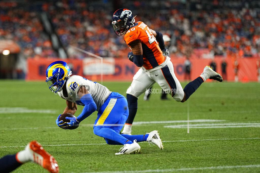 Los Angeles Rams wide receiver Jeremiah Haydel (18) makes a catch as Denver Broncos linebacker Justin Strnad (40) defends during the second half of an NFL preseason football game, Saturday, Aug. 28, 2021, in Denver. (AP Photo/Jack Dempsey)