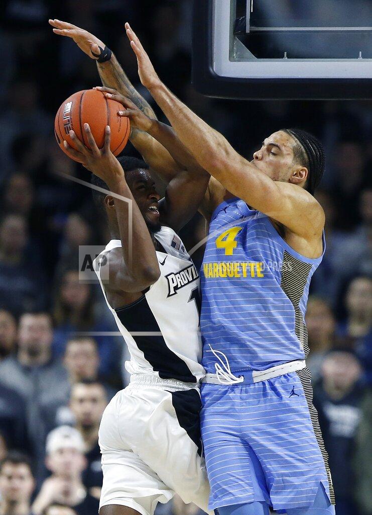 Michael Dwyer Marquette's Theo John (4) blocks a shot by Providence's Alpha Diallo during the second half of an NCAA college basketball game in Providence, R.I., Saturday, Feb. 23, 2019. (AP Photo/Michael Dwyer)