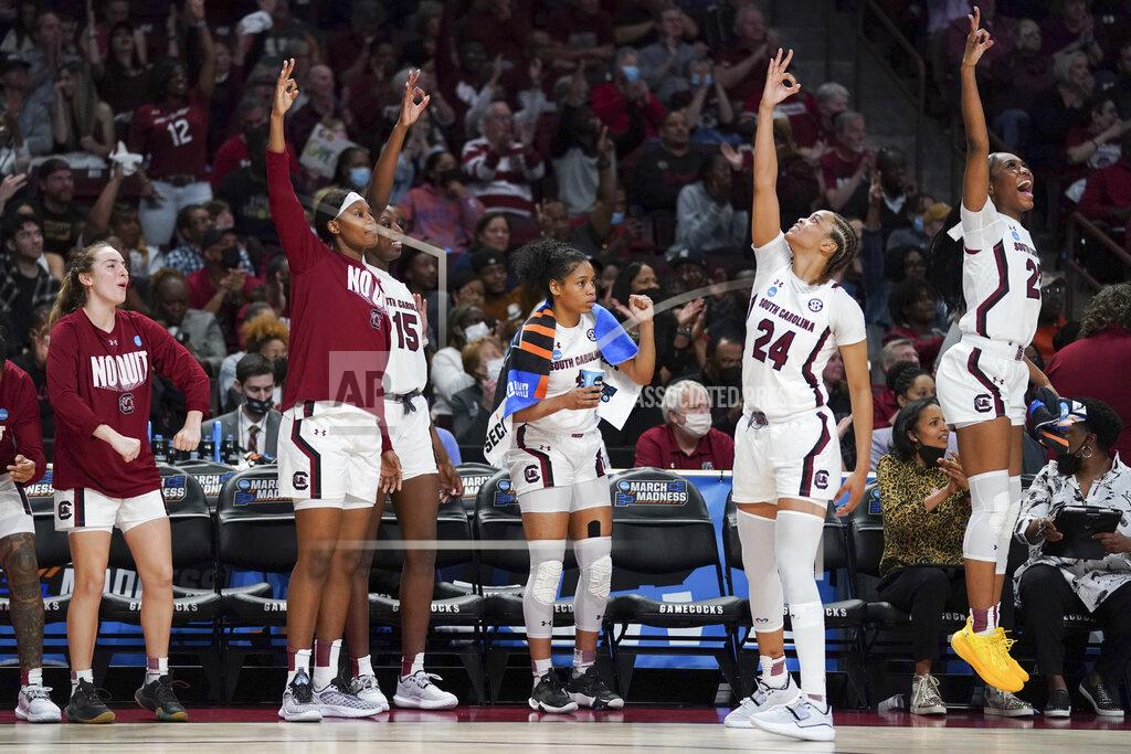Sean Rayford South Carolina players celebrate a 3-pointer during the first half of a second-round game against Miami in the NCAA college basketball tournament, Sunday, March 20, 2022, in Columbia, S.C. (AP Photo/Sean Rayford)
