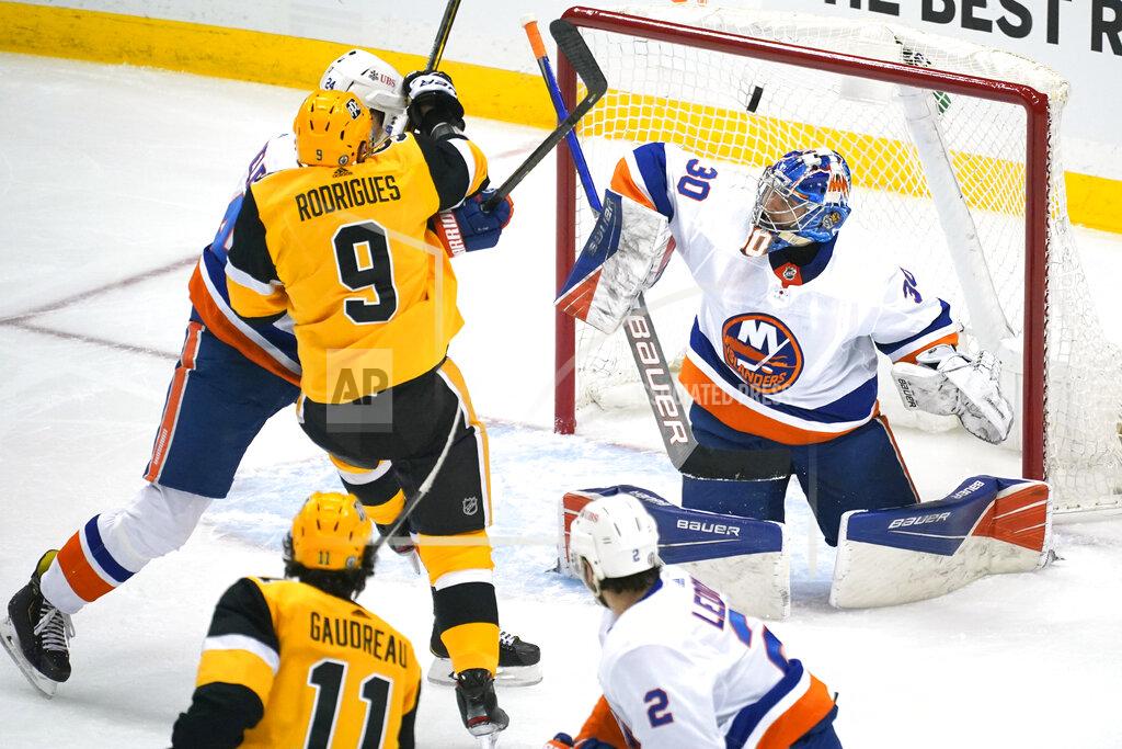 Gene J. Puskar Pittsburgh Penguins' Frederick Gaudreau (11) puts a shot over New York Islanders goaltender Ilya Sorokin (30) for a goal during the first period of Game 1 of an NHL hockey Stanley Cup first-round playoff series in Pittsburgh, Sunday, May 16, 2021. (AP Photo/Gene J. Puskar)