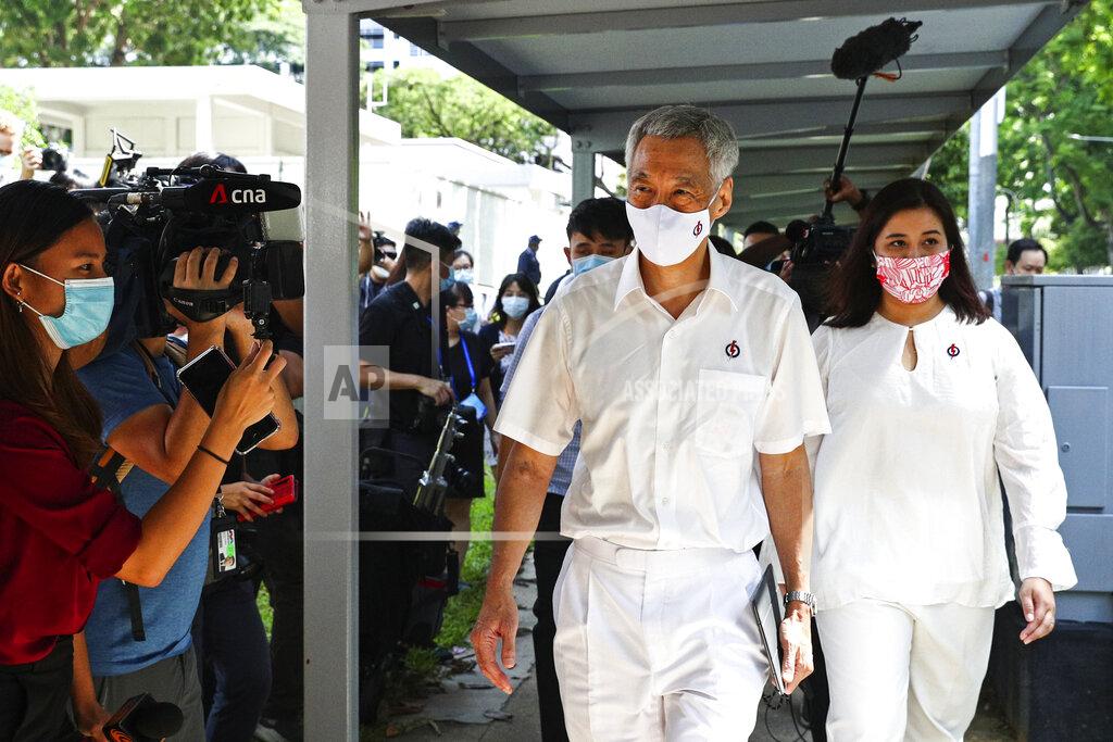 Yong Teck Lim People's Action Party Secretary-General and Singaporean Prime Minister Lee Hsien Loong, center, arrives at a nomination center with his team to submit their nomination papers ahead of the general election in Singapore, Tuesday, June 30, 2020. Campaigning has begun for Singapore’s general elections, with the opposition hoping to dent the ruling party’s supermajority in parliament with support from Prime Minister Lee’s estranged younger brother. (AP Photo/Yong Teck Lim)