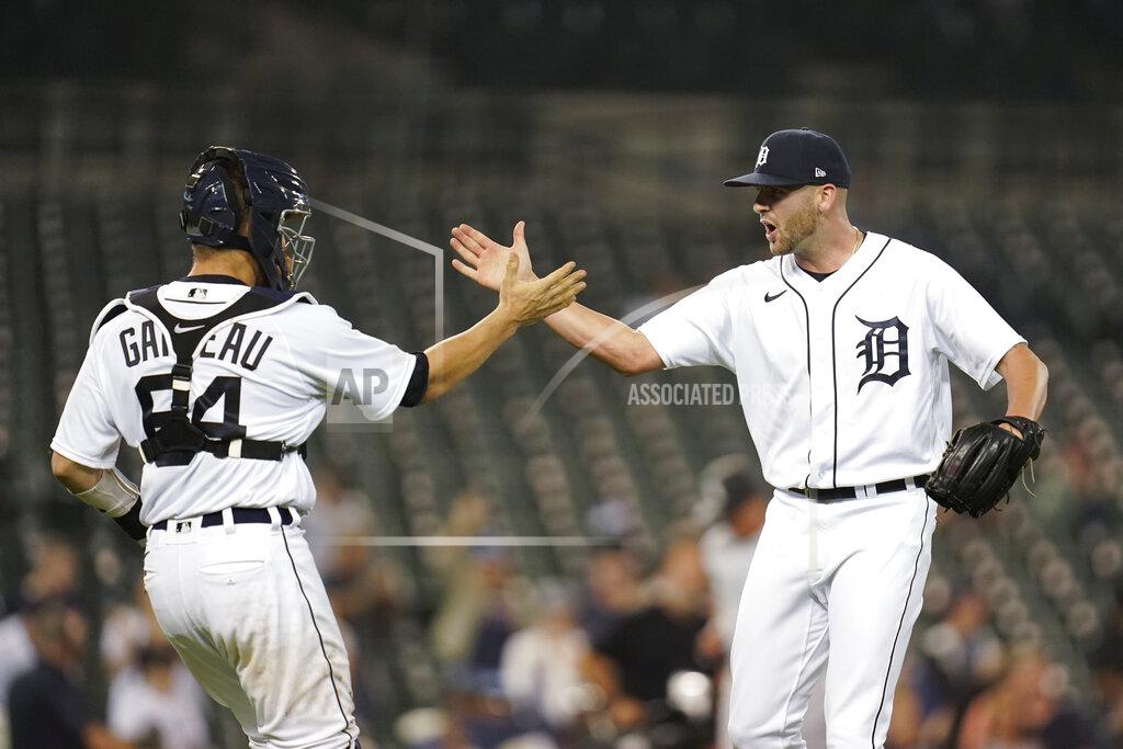 Paul Sancya Detroit Tigers catcher Dustin Garneau (64) and pitcher Alex Lange celebrate after the final out in the ninth inning of a baseball game against the Chicago White Sox in Detroit, Monday, Sept. 20, 2021. Detroit won 4-3. (AP Photo/Paul Sancya)