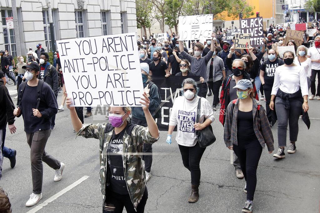 Jeff Chiu People march toward City Hall during a protest over the Memorial Day death of George Floyd, a handcuffed black man in police custody in Minneapolis, in San Francisco, Saturday, May 30, 2020. (AP Photo/Jeff Chiu)