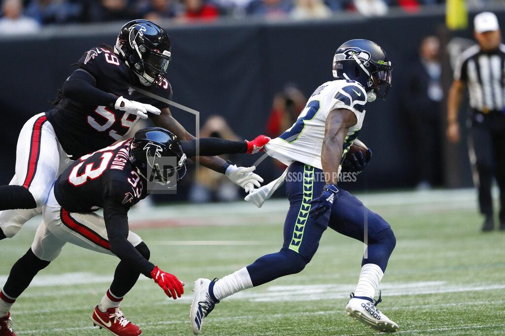 John Bazemore Atlanta Falcons defensive back Blidi Wreh-Wilson (33) misses the tackle on Seattle Seahawks wide receiver David Moore (83) during the second half of an NFL football game, Sunday, Oct. 27, 2019, in Atlanta. (AP Photo/John Bazemore)