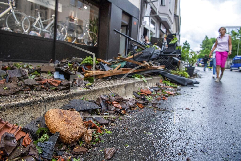 Lino Mirgeler A loaf of bread lies among the debris on the edge of a downtown street in Paderborn, Germany, Friday, May 20, 2022. Meteorologists had warned that heavy rainfall and hail were expected in western and central Germany on Friday, with storms producing wind gusts up to 130 kph (81 mph). (Lino Mirgeler/dpa via AP)