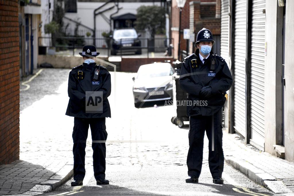 Alberto Pezzali Police officers stand guard at the side entrance of the King Edward VII Hospital where Britain's Prince Philip is receiving treatment as a police van stands guard, in London, Sunday, March 14, 2021. The 99-year-old husband of Queen Elizabeth II remains hospitalized after a heart procedure. (AP Photo/Alberto Pezzali)