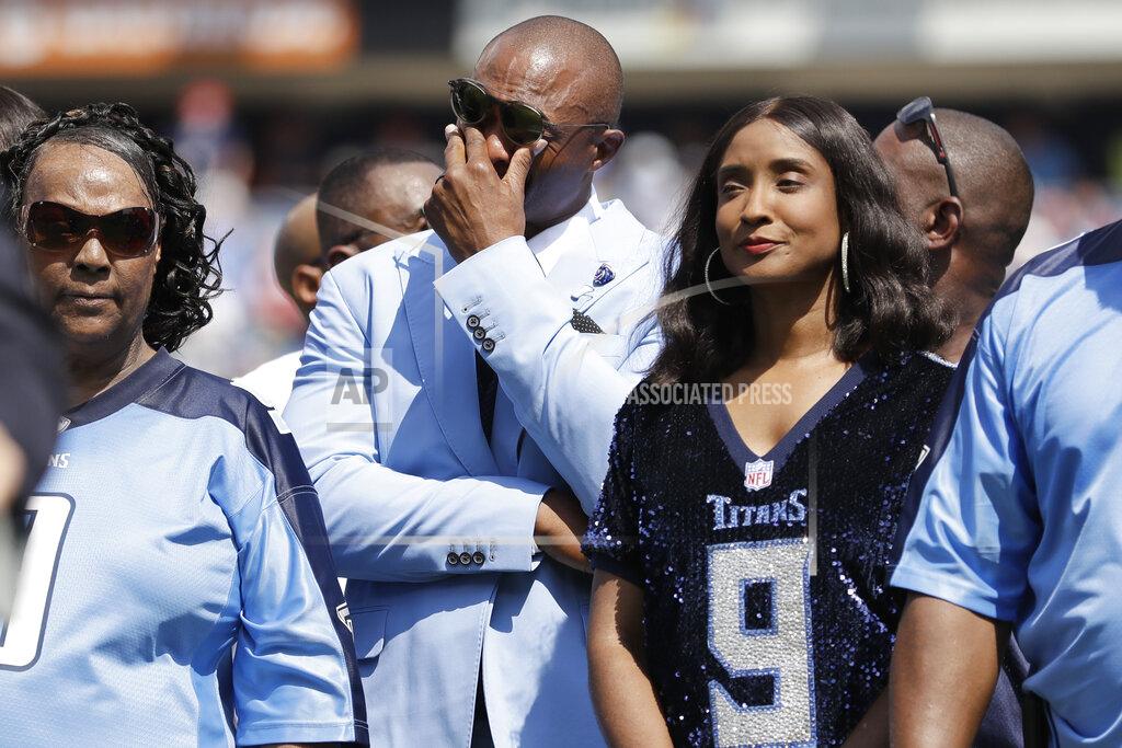 James Kenney Former Tennessee Titans running back Eddie George, center, wipes his eyes as his number 27 is retired during a halftime ceremony at an NFL football game between the Titans and the Indianapolis Colts Sunday, Sept. 15, 2019, in Nashville, Tenn. The number 9 of the late Titans quarterback Steve McNair was also retired. (AP Photo/James Kenney)