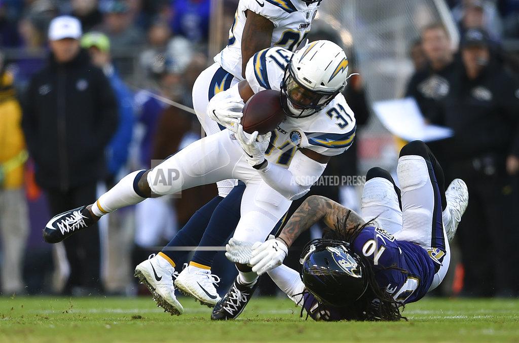 Gail Burton Los Angeles Chargers defensive back Adrian Phillips (31) intercepts a pass attempt in front of Baltimore Ravens wide receiver Chris Moore in the first half of an NFL wild card playoff football game, Sunday, Jan. 6, 2019, in Baltimore. (AP Photo/Gail Burton)