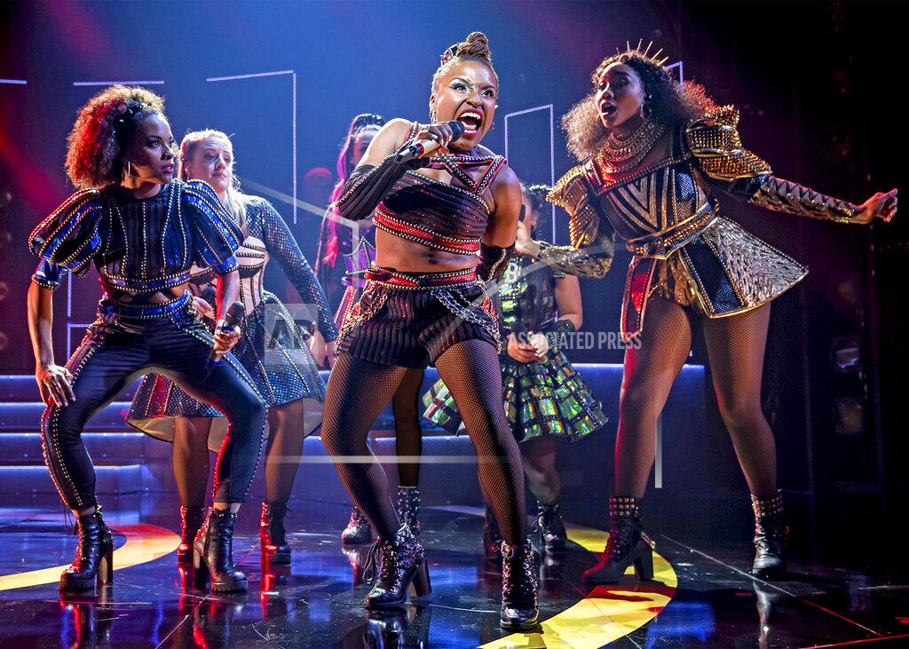 Liz Lauren This image released by Boneau/Bryan Brown shows Brittney Mack, center, during a performance of "Six." Samantha Pauly and Mack, who play two wives of Henry VIII in the musical “Six,” have turned their disappointment at having their musical on hold by doing what they do best — sing. Mack sings gospel songs to tunes from classic shows like "State Fair. " The daily songs are just one way that theater folk have passed the time since Broadway went dark. (Liz Lauren/Boneau/Bryan Brown via AP)