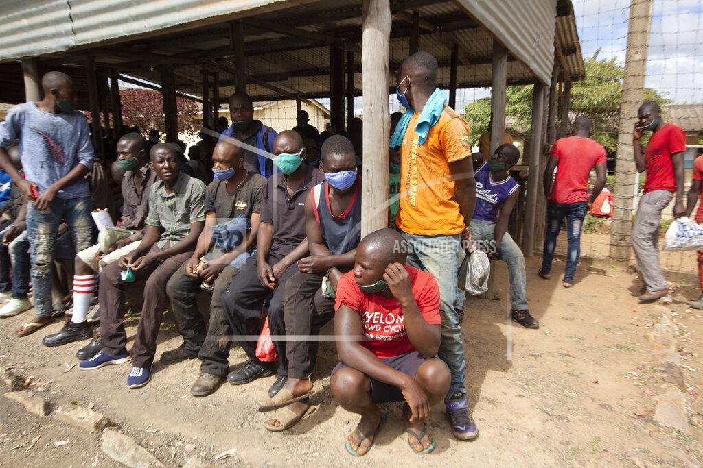 Tsvangirayi Mukwazhi Prisoners wait for transport following their release from Chikurubi prison on the outskirts of Harare, Saturday, April 17, 2021. Zimbabwe began the release of about 3,000 prisoners under a presidential amnesty aimed at easing congestion and minimizing the threat of COVID-19 across the country's overcrowded jails. (AP Photo/Tsvangirayi Mukwazhi)