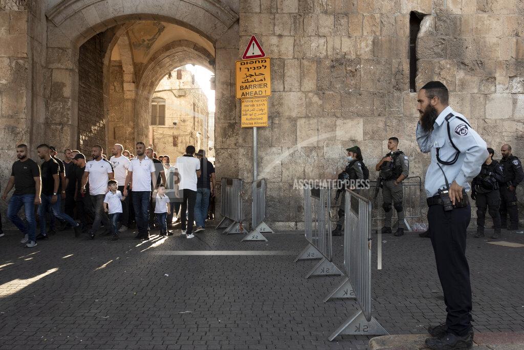 Maya Alleruzzo Israeli police stand guard at near the Lion's Gate as Palestinian protesters march into the Al Aqsa Mosque compound in the Old City of Jerusalem, Friday, Sept. 10, 2021. Amid increased Israeli-Palestinian tension over a recent prison break, Israeli police said an officer was lightly injured by a firearm in an attempt to thwart a suspected stabbing attack in the area. The Police, which arrested the suspect, did not immediately say how the officer was injured. (AP Photo/Maya Alleruzzo)