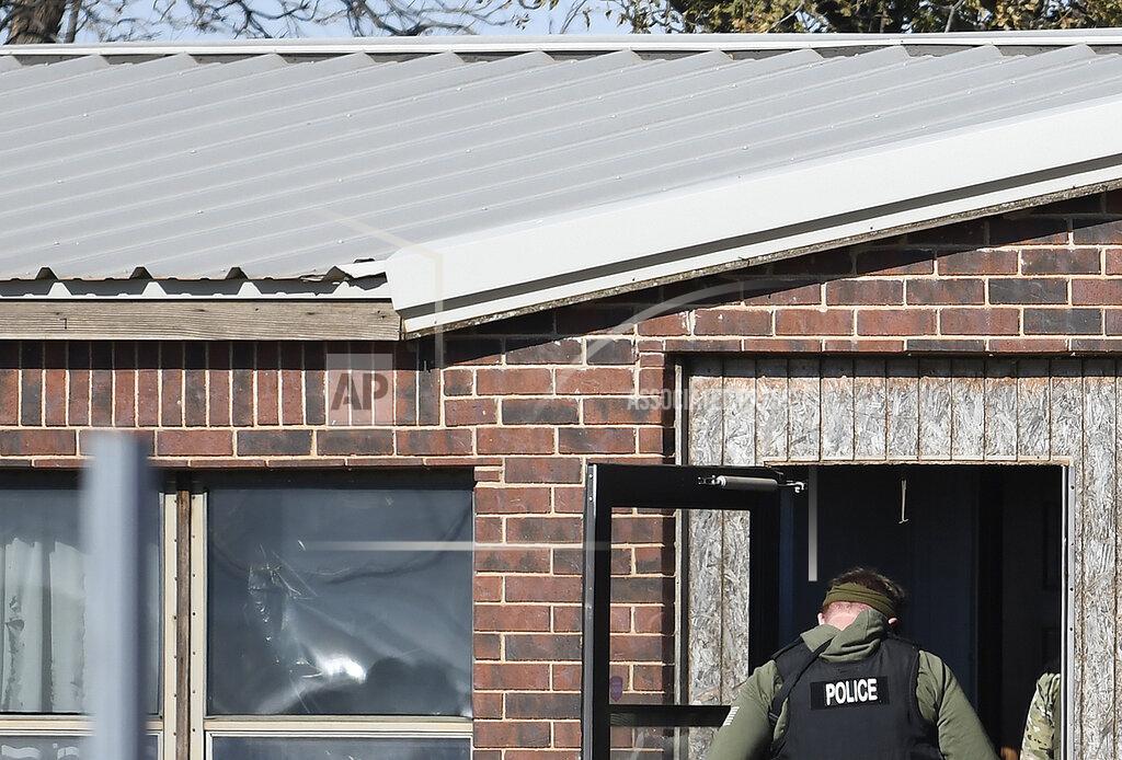 Billy Hefton A law enforcement officer enters a residence near Lacey, Okla., in Kingfisher County, Monday, Nov. 21, 2022, the was the scene of a quadruple homicide. State police in Oklahoma say that four people killed at a marijuana farm were "executed," and that they were Chinese citizens. (Billy Hefton/The Enid News & Eagle via AP)