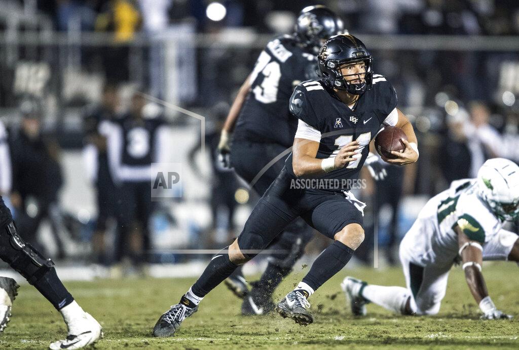 Willie J. Allen Jr. Central Florida quarterback Dillon Gabriel (11) runs out of the pocket during the second half of the team's NCAA college football game against South Florida, Friday, Nov. 29, 2019, in Orlando, Fla. (AP Photo/Willie J. Allen Jr.)