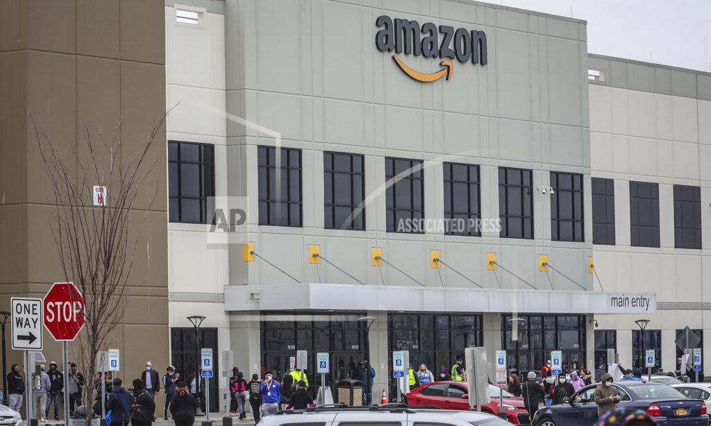 FILE - In this March 30, 2020 file photo, workers at Amazon's fulfillment center in Staten Island, N.Y., gather outside to protest work conditions in the company's warehouse in New York. Amazon is facing a lawsuit from the New York Attorney General’s office that claims the online shopping powerhouse didn’t provide adequate health and safety measures for workers at its New York facilities during the coronavirus pandemic and took retaliatory action against multiple employees. (AP Photo/Bebeto Matthews, File)
