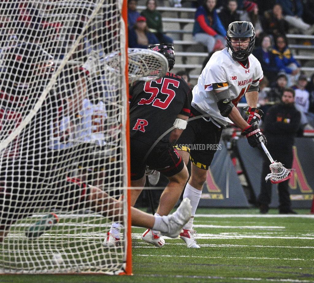 Kenneth K. Lam Maryland's Jack Brennan, right, shoots past Rutgers' Brad Apgar (55) in the second quarter to score Maryland's eighth goal of the game at Maryland Stadium. April 10, 2022 in College Park, Md. Doctors learned early in the pandemic that COVID-19 was more than a respiratory disease. It was attacking bodily organs, including the heart — even in healthy, young athletes. (Kenneth K. Lam/The Baltimore Sun via AP)