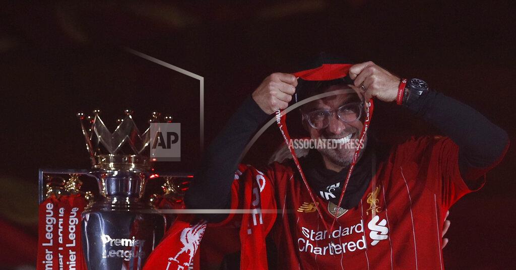 Phil Noble Liverpool's manager Jurgen Klopp puts on his winner medal prior to his team lifting the English Premier League trophy following the English Premier League soccer match between Liverpool and Chelsea at Anfield Stadium in Liverpool, England, Wednesday, July 22, 2020. Liverpool are champions of the EPL for the season 2019-2020. The trophy is presented at the teams last home game of the season. Liverpool won the match against Chelsea 5-3. (Phil Noble/Pool via AP)