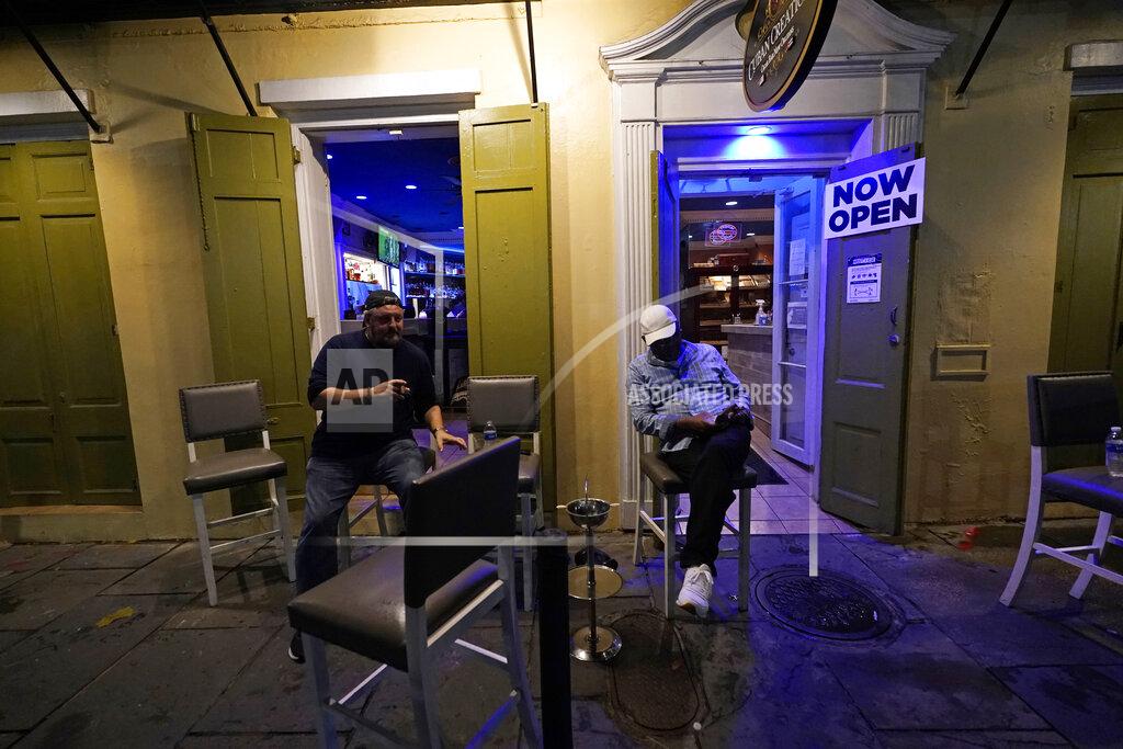 Gerald Herbert Patrons resume their socializing at Cuban Cigar Bar in the French Quarter in New Orleans, after power was restored Wednesday, Oct. 28, 2020. Hurricane Zeta passed through today leaving much of the city and metro area without power. (AP Photo/Gerald Herbert)