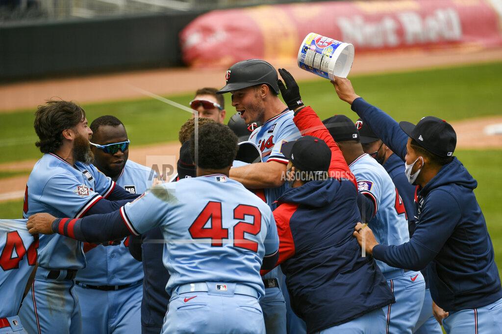 Craig Lassig Minnesota Twins' Max Kepler, center with helmet, celebrates with his team after driving in the winning run in the ninth inning of a baseball game against the Boston Red Sox, Thursday, April 15, 2021, in Minneapolis. The Twins won 4-3. (AP Photo/Craig Lassig)