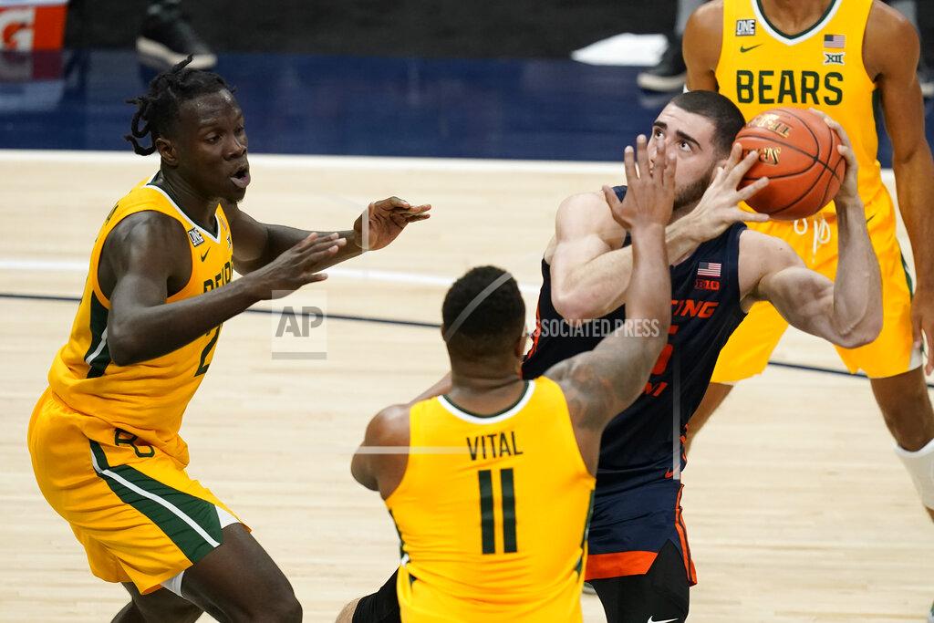 Darron Cummings Illinois' Giorgi Bezhanishvili (15) looks to shoot as Baylor's Mark Vital (11) and Jonathan Tchamwa Tchatchoua (23) defend during the first half of an NCAA college basketball game Wednesday, Dec. 2, 2020, in Indianapolis. (AP Photo/Darron Cummings)