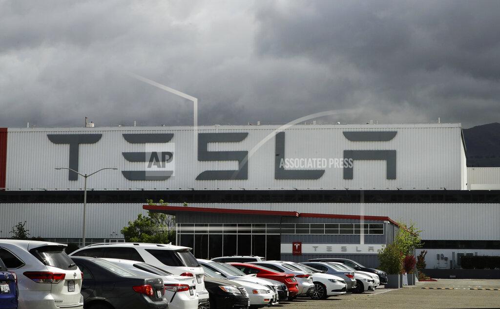 FILE - This Tuesday, May 12, 2020, file photo shows the Tesla plant, in Fremont, Calif. Some Tesla workers and labor activists say the company is threatening to fire employees who haven’t returned to the company’s California factory since it reopened because they're afraid of catching the coronavirus. (AP Photo/Ben Margot, File)