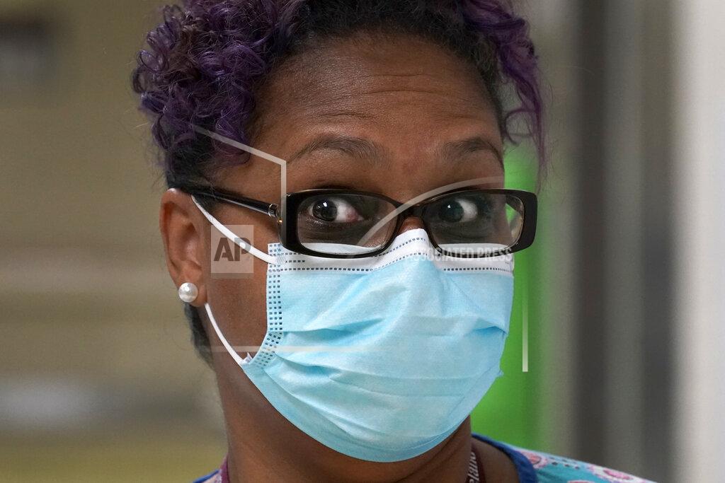 Charles Rex Arbogast Roseland Community Hospital RN Rhonda Jones, reacts Friday, Jan. 29, 2021, when asked why she is hesitant to take the COVID-19 vaccine at the South Side Chicago hospital. Jones has treated many patients with severe COVID-19, a relative died from it, and her mother and a nephew were infected and recovered, but she is still holding out. The vaccines “came out just too fast’ and haven’t been adequately tested, she said. She doesn’t rule out getting vaccinated, but not any time soon. (AP Photo/Charles Rex Arbogast)