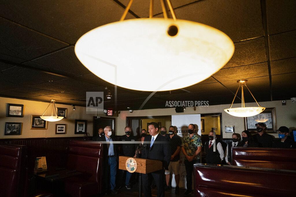 Florida Gov. Ron DeSantis speaks during a news conference at the Okeechobee Steakhouse on Tuesday, Dec. 15, 2020 in West Palm Beach, Fla. (Greg Lovett/The Palm Beach Post via AP)