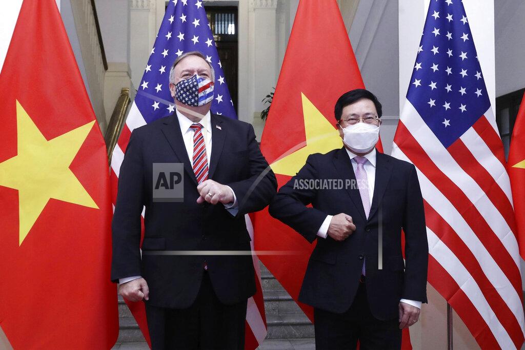 Bui Lam Khanh U.S. Secretary of State Mike Pompeo, left, and Vietnamese Foreign Minister Pham Binh Minh pose for a photo before a meeting in Hanoi, Vietnam, Friday, Oct. 30, 2020. Pompeo is wrapping up an anti-China tour of Asia in Vietnam as the fierce American presidential election race enters its final stretch. (Bui Lam Khanh/VNA via AP)