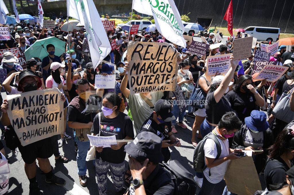 Aaron Favila Protesters hold slogans during a rally against presidential frontrunner Ferdinand "Bongbong" Marcos and running mate Sara Duterte, daughter of the current president, during a rally in Pasay, Philippines, Friday, May 13, 2022. Allies of the Philippines' presumptive next president, Marcos Jr., appear set to strongly dominate both chambers of Congress, further alarming activists after the late dictator's son scored an apparent election victory that will restore his family to the seat of power. (AP Photo/Aaron Favila)