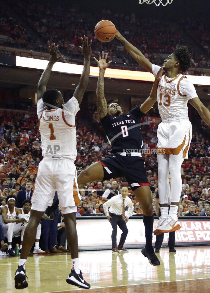 Eric Gay Texas Tech guard Kyler Edwards (0) is blocked by Texas guard Jase Febres (13) as he tries to score during the first half of an NCAA college basketball game, Saturday, Feb. 8, 2020, in Austin, Texas. (AP Photo/Eric Gay)
