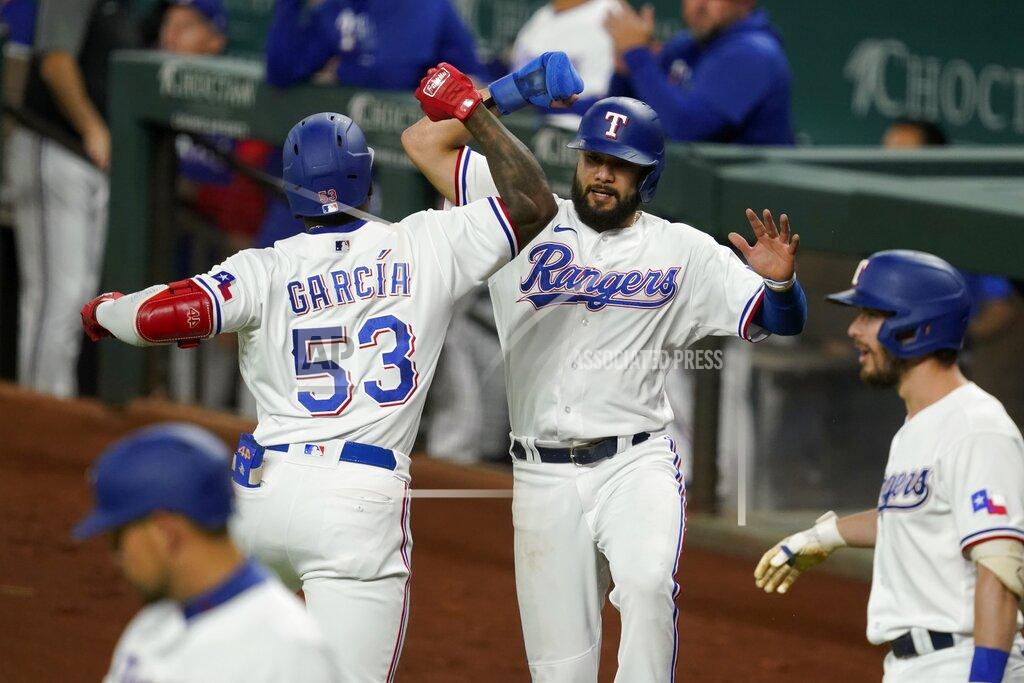 Tony Gutierrez Texas Rangers' Adolis Garcia (53) and Isiah Kiner-Falefa, center right, celebrate Garcia's two-run home run that scored Kiner-Falefa against the Houston Astros during the the third inning of a baseball game in Arlington, Texas, Tuesday, Sept. 14, 2021. In the foreground are Rangers' Nathaniel Lowe, left, and Nick Solak. (AP Photo/Tony Gutierrez)