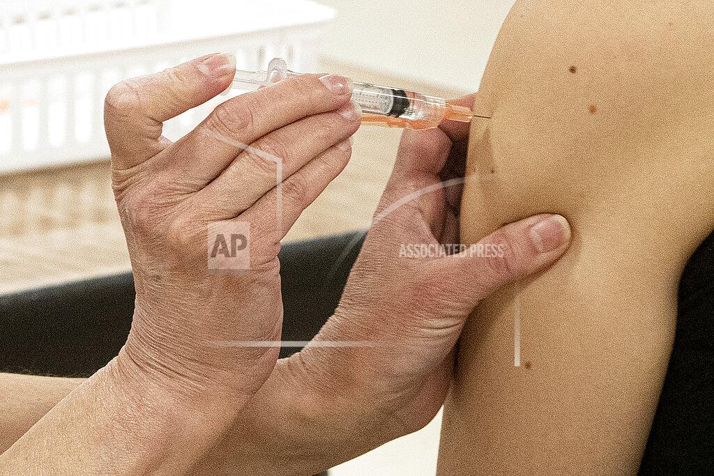 Phil Long FILE-This Thursday, April 8, 2021 file phtoto shows Kent State University student Regan Raeth, of Hudson, Ohio, having her COVID-19 vaccination administered by Kent State nurse Kristen Barath in Kent, Ohio. The nation's largest traditional supermarket chain and some college campuses are among the Ohio providers that temporarily stopped using the Johnson & Johnson coronavirus vaccine Tuesday, April 13, while federal officials investigate reports of potentially dangerous blood clots. Kent State University said it was postponing its J&J clinics until further notice. (AP Photo/Phil Long, File)