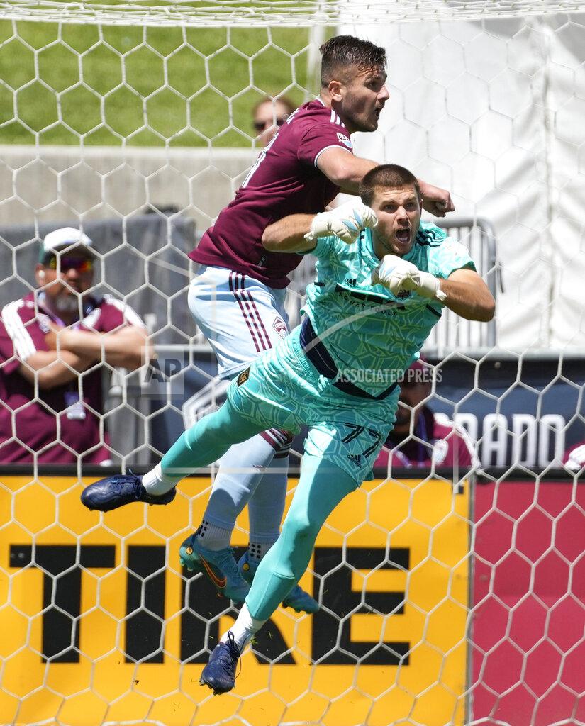 David Zalubowski Los Angeles FC goalkeeper John McCarthy, front, dives under Colorado Rapids forward Diego Rubio to block a shot in the first half of an MLS soccer match Saturday, May 14, 2022, in Commerce City, Colo. (AP Photo/David Zalubowski)
