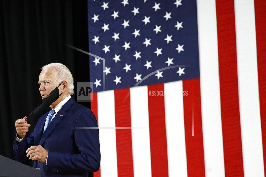 Patrick Semansky Democratic presidential candidate, former Vice President Joe Biden removes a face mask to protect against the spread of the new coronavirus as he arrives to speak at Alexis Dupont High School in Wilmington, Del., Tuesday, June 30, 2020. (AP Photo/Patrick Semansky)
