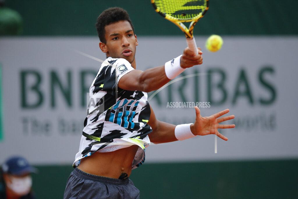 Christophe Ena Canada's Felix Auger-Aliassime plays a shot against Japan's Yoshihito Nishioka in the first round match of the French Open tennis tournament at the Roland Garros stadium in Paris, France, Monday, Sept. 28, 2020. (AP Photo/Christophe Ena)