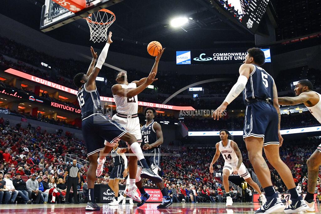 Timothy D. Easley Louisville forward Sydney Curry (21) shoots over Duke center Mark Williams (15) during the second half of an NCAA college basketball game in Louisville, Ky., Saturday, Jan. 29, 2022. Duke won 74-65. (AP Photo/Timothy D. Easley)