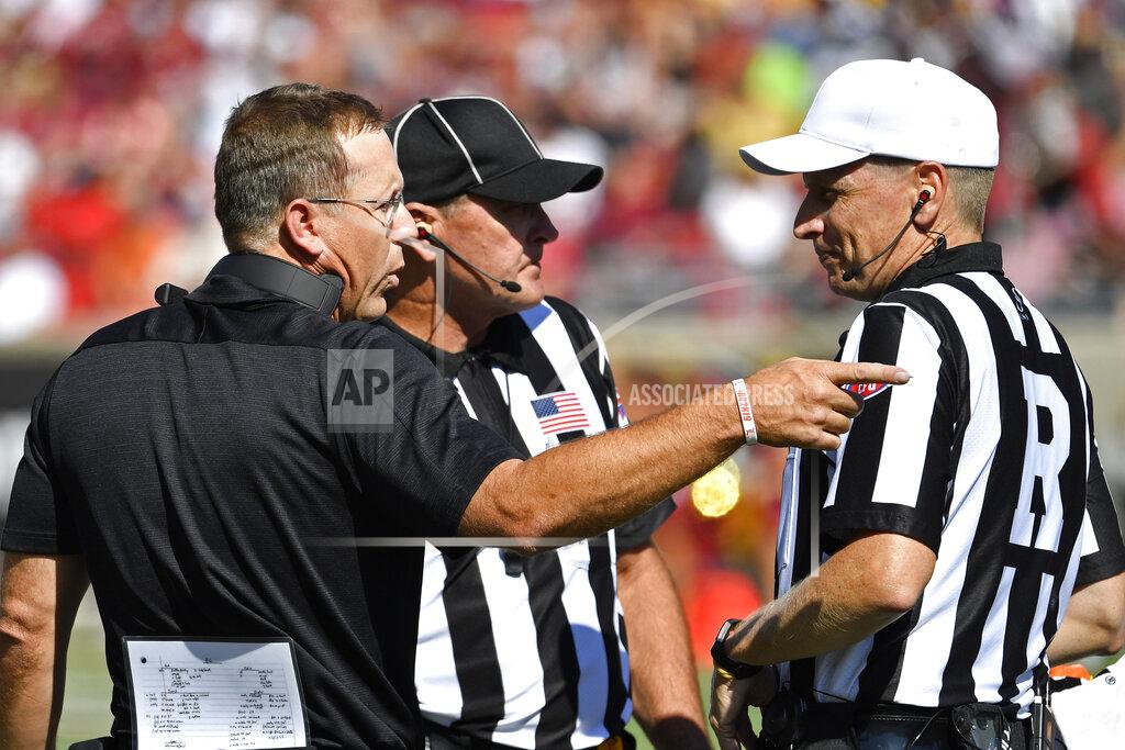 Timothy D. Easley Louisville head coach Scott Satterfield, left, argues a call with a referee during the second half of an NCAA college football game in Louisville, Ky., Saturday, Oct. 5, 2019. Louisville won 41-39. (AP Photo/Timothy D. Easley)