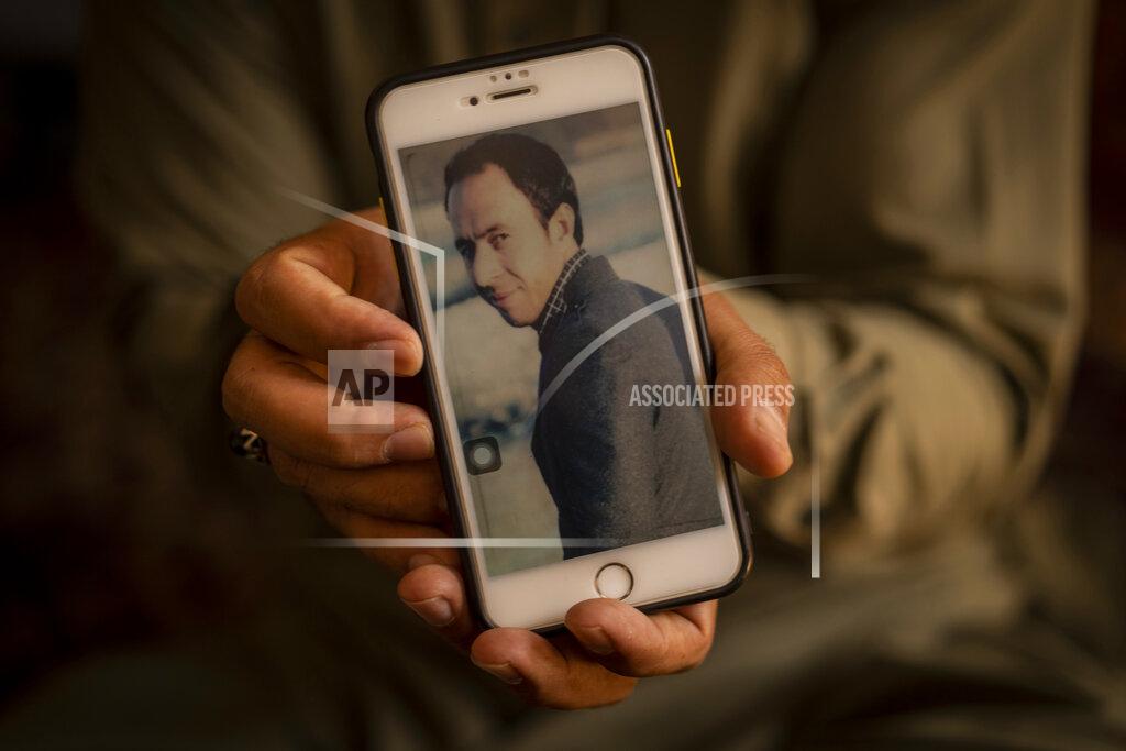 Bernat Armangue Amal Ahmadi, 32, holds a picture of his slain brother Zemerai Ahmadi at the family house in Kabul, Afghanistan, Monday, Sept. 13, 2021. Zemerai Ahmadi the Afghan man who was killed in a U.S. drone strike last month was an enthusiastic and beloved longtime employee at an American humanitarian organization, his colleagues say, painting a stark contrast to the Pentagon’s claims that he was an Islamic State group militant about to carry out an attack on American troops. (AP Photo/Bernat Armangue)