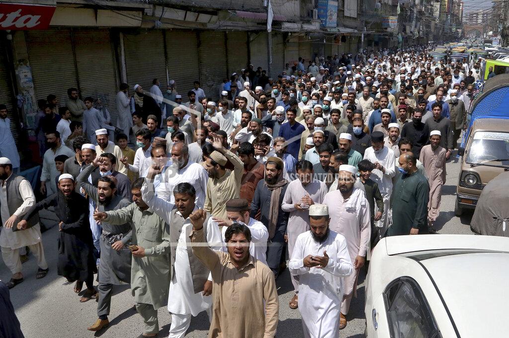 Muhammad Sajjad Traders hold a rally to condemn the security forces's crackdown against a banned Tehreek-e-Labaik Pakistan party, in Peshawar, Pakistan, Monday, April 19, 2021. An outlawed Pakistani Islamist political group freed 11 policemen almost a day after taking them hostage in the eastern city of Lahore amid violent clashes with security forces, the country's interior minister said Monday. (AP Photo/Muhammad Sajjad)