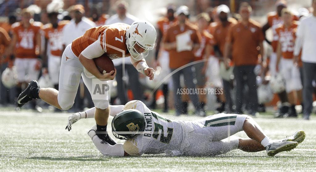 Eric Gay Texas quarterback Shane Buechele (7) is tripped by Baylor safety Blake Lynch (21) during the first half of an NCAA college football game, Saturday, Oct. 13, 2018, in Austin, Texas. (AP Photo/Eric Gay)