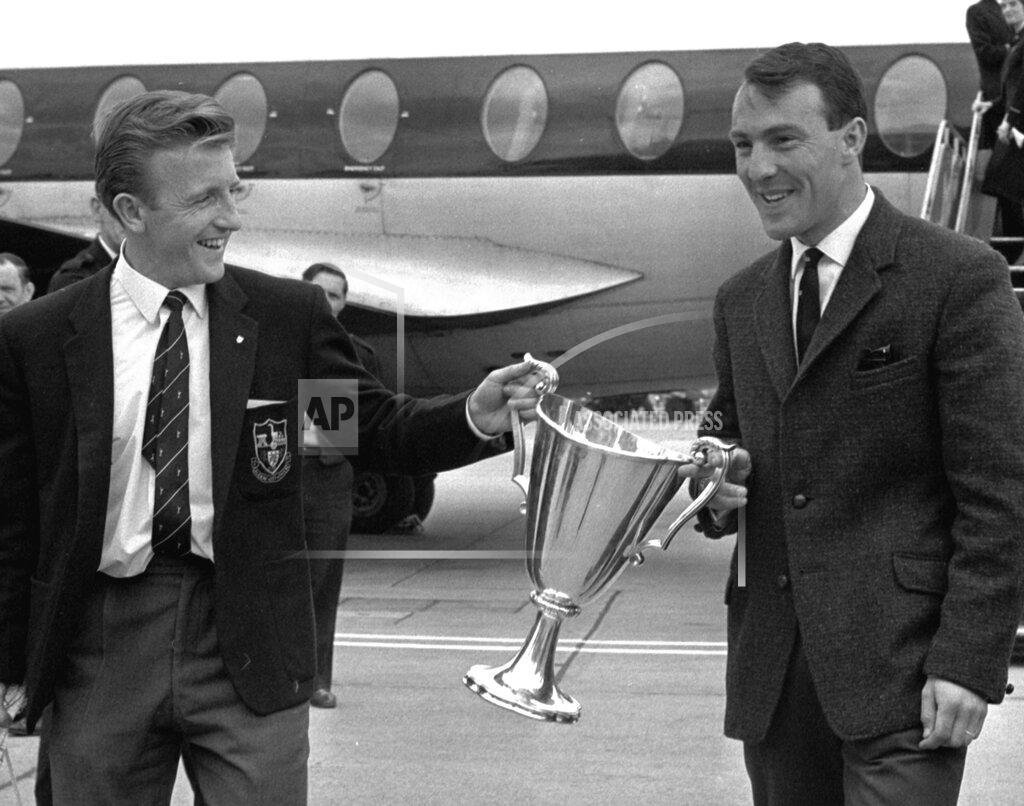 Victor Boynton FILE - In this May 16, 1963 file photo, Tottenham Hotspur forwards Jimmy Greaves, right, and Terry Dyson carry the European Cup Winners Cup, at London's Heathrow airport. Spurs defeated Athletico Madrid 5-1 in the European Cup Winners Cup Final becoming the first British club to win the tournament. Jimmy Greaves, one of England’s greatest goal-scorers who was prolific for Tottenham, Chelsea and AC Milan has died. He was 81. With 266 goals in 379 appearances, Greaves was the all-time record scorer for Tottenham, which announced his death on Sunday, Sept. 19, 2021. (AP Photo/Victor Boynton, File)