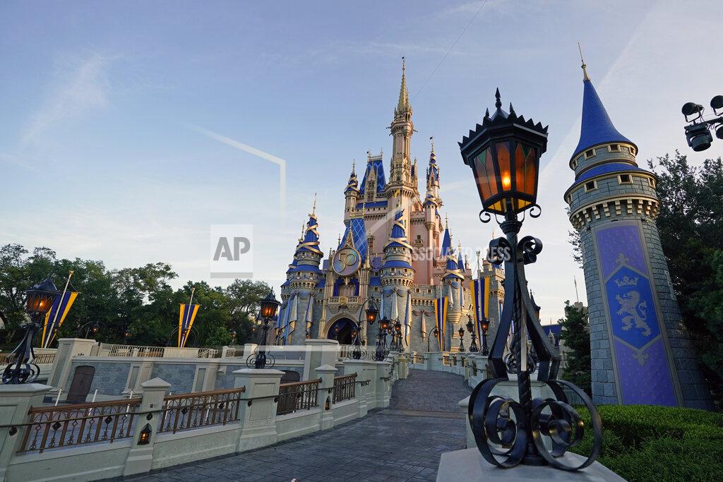 John Raoux The newly painted Cinderella Castle at the Magic Kingdom at Walt Disney World is seen with the the crest to celebrate the 50th anniversary of the theme park Monday, Aug. 30, 2021, in Lake Buena Vista, Fla. (AP Photo/John Raoux)