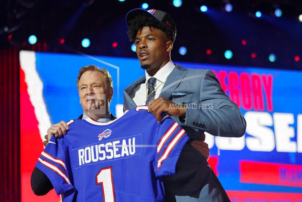 Tony Dejak Miami edge rusher Gregory Rousseau, right, holds a team jersey with NFL Commissioner Roger Goodell after the Buffalo Bills selected Rousseau with the 30th pick in the first round of the NFL football draft Thursday April 29, 2021, in Cleveland. (AP Photo/Tony Dejak)